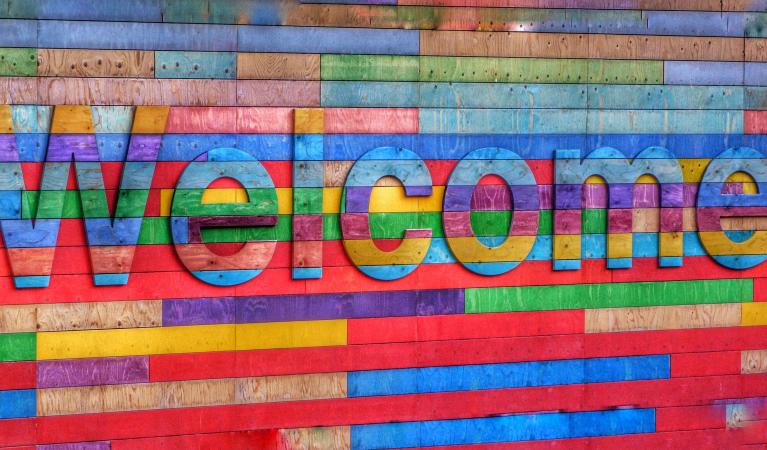 Text "welcome" on a very colorful background.