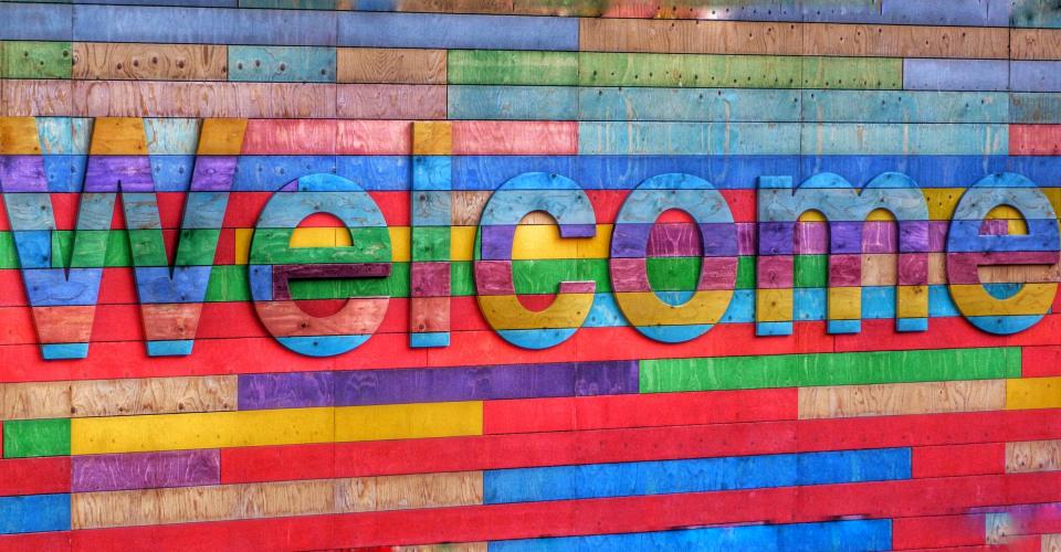 Text "welcome" on a very colorful background.